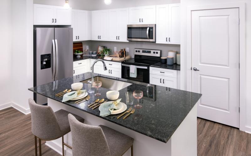 a kitchen with a black countertop