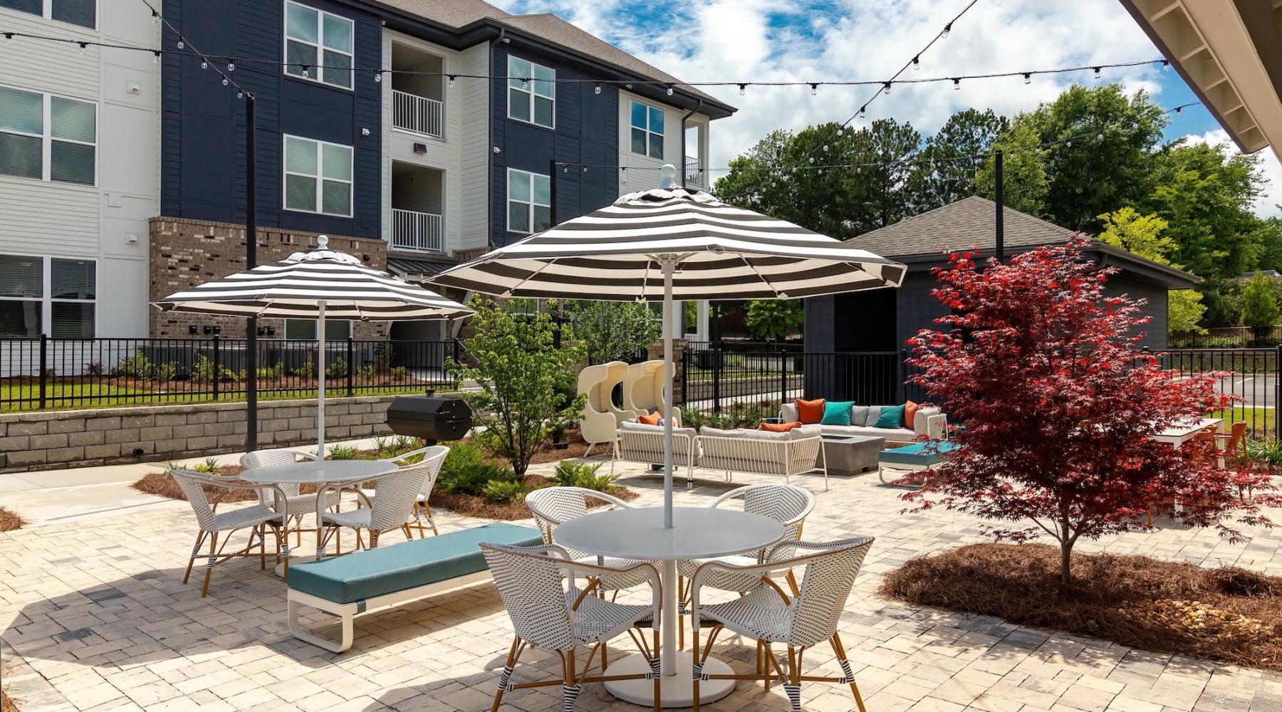 an outdoor lounge area with umbrellas