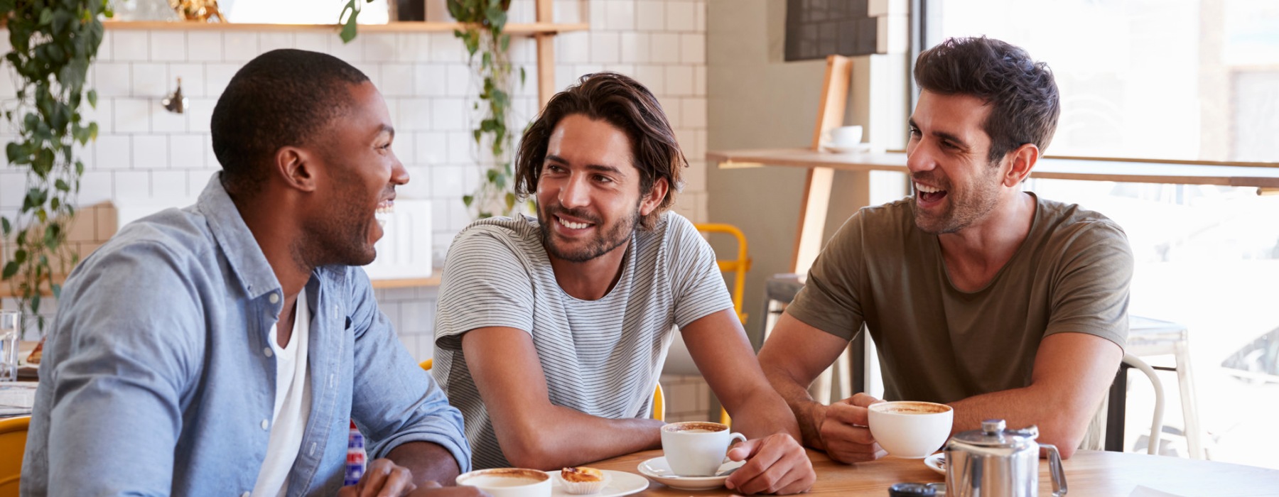 three men talking over breakfast in a restaurant