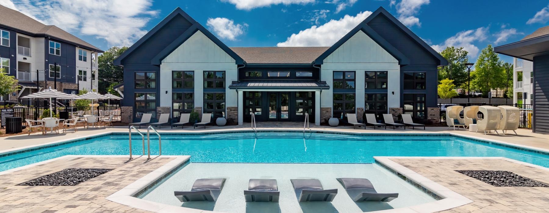 a swimming pool in front of a house